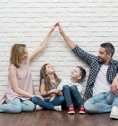 family is sitting inside the house