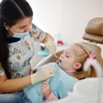 Little baby girl at dentist chair Children dental