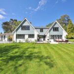 White and Gray Wooden House Near Grass Field and Trees