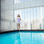 woman posing outdoor in summer in hot weather on pool