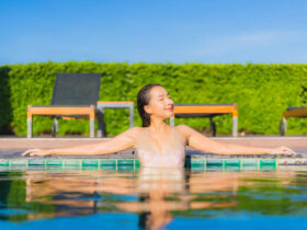 young asian woman relaxing around outdoor swimming pool