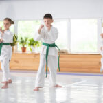 active boys and girl feeling serious while studying martial art