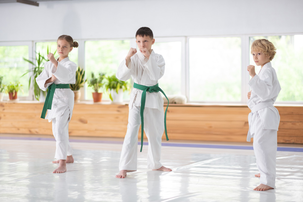 active boys and girl feeling serious while studying martial art