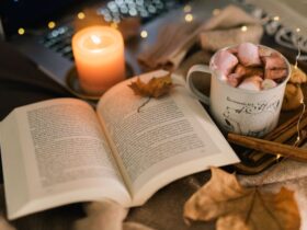 Close-Up Shot of a Cup of Coffee beside a Book