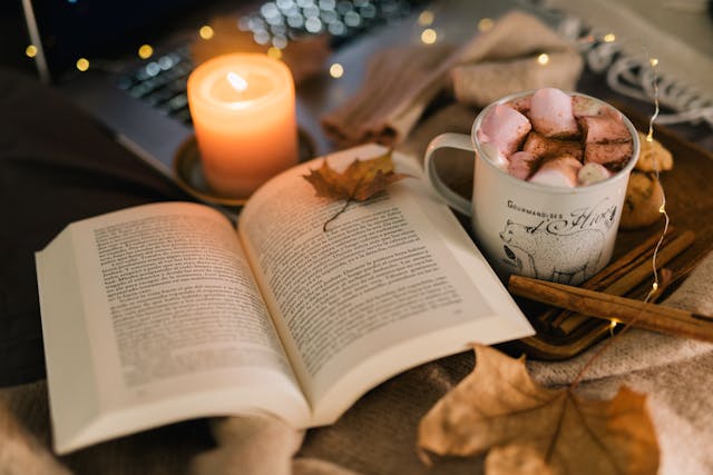 Close-Up Shot of a Cup of Coffee beside a Book