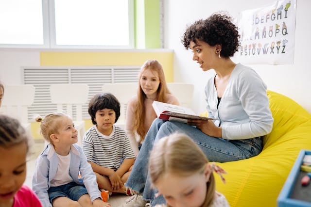 Woman Reading A Book To The Children