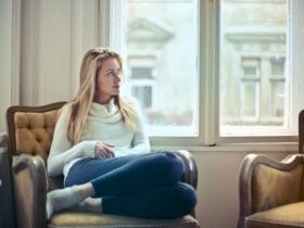 Woman Sitting on Chair Near Window