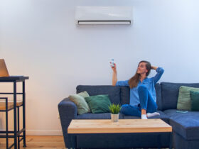 woman sitting on couch under air conditioner