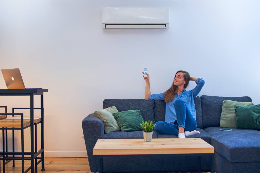 woman sitting on couch under air conditioner