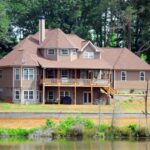 Brown Wooden House Near Forest and Water