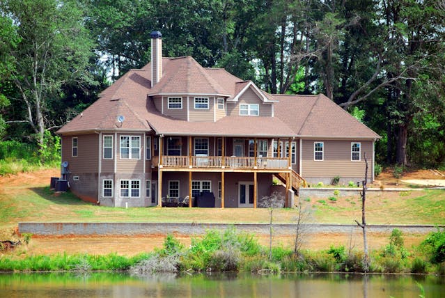 Brown Wooden House Near Forest and Water